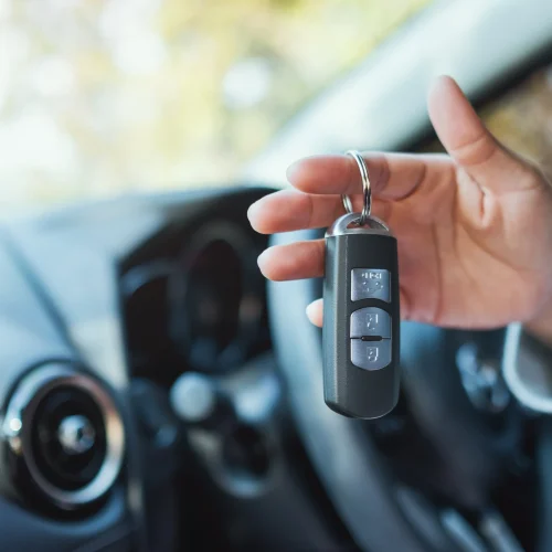 a-woman-holding-and-showing-car-key-while-sitting-2026-03-13-04-18-27-utc-copy-scaled.webp